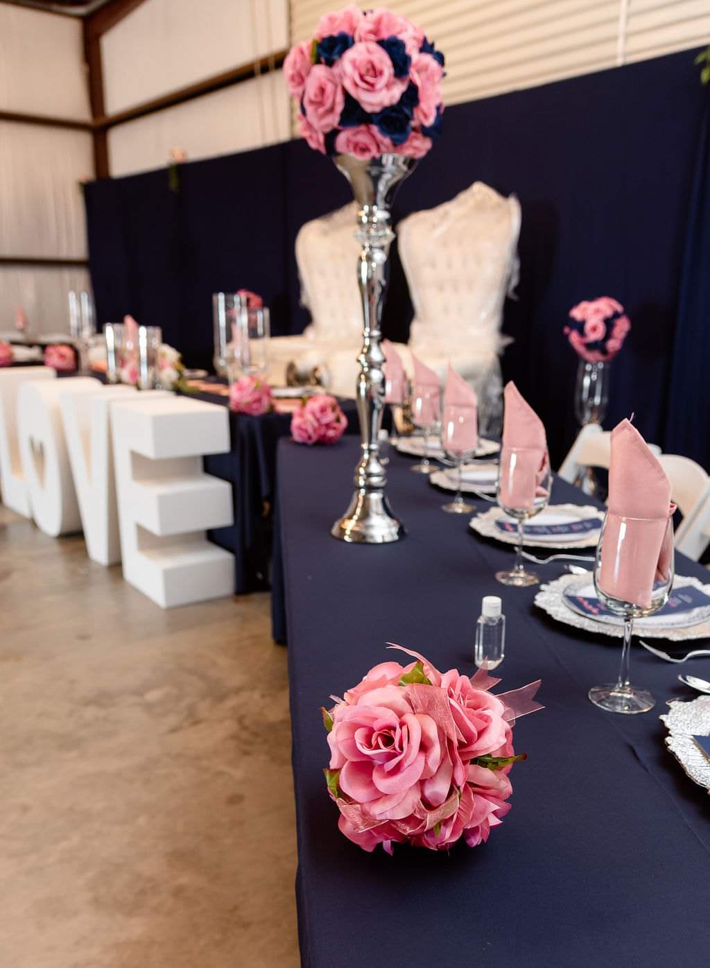 Navy and blush tablescape with silver candelabras and rose centerpieces