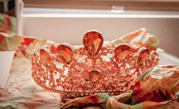 Rose gold crystal tiara resting on floral fabric in the getting ready suite at Reverie at Diamond D