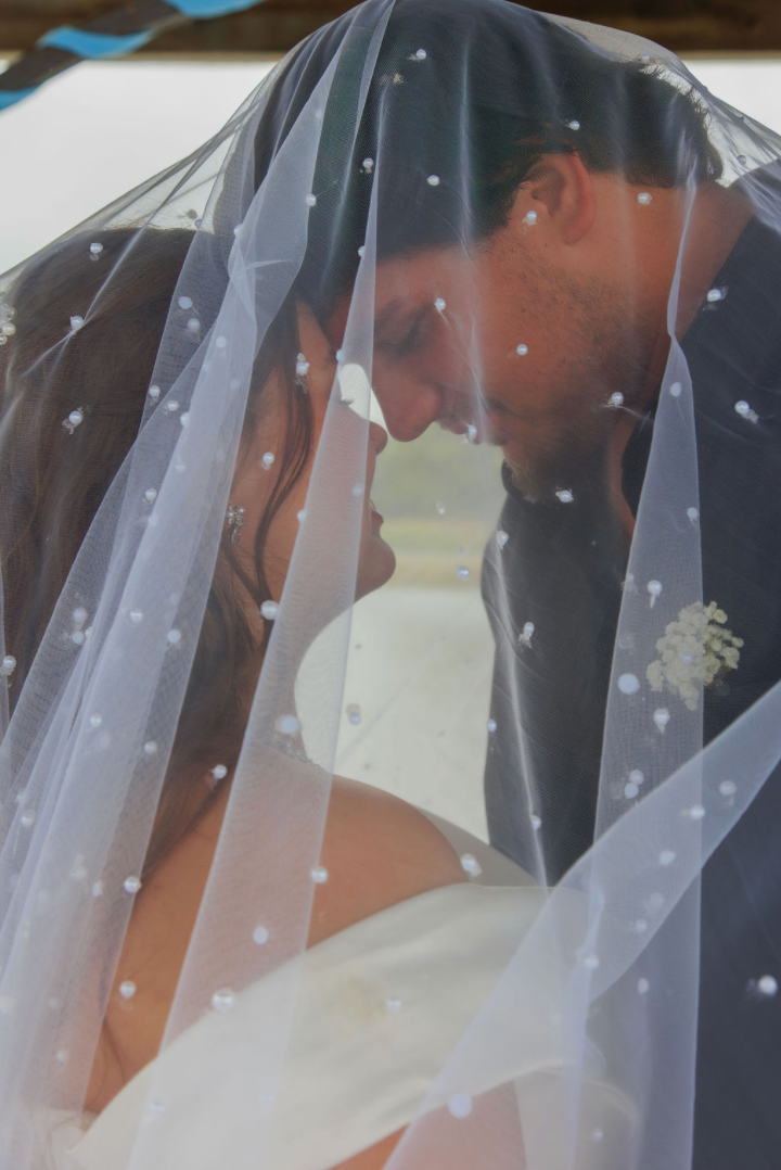 Jaelyn & Keelan's wedding at Reverie at Diamond D — the couple beneath the veil, foreheads touching
