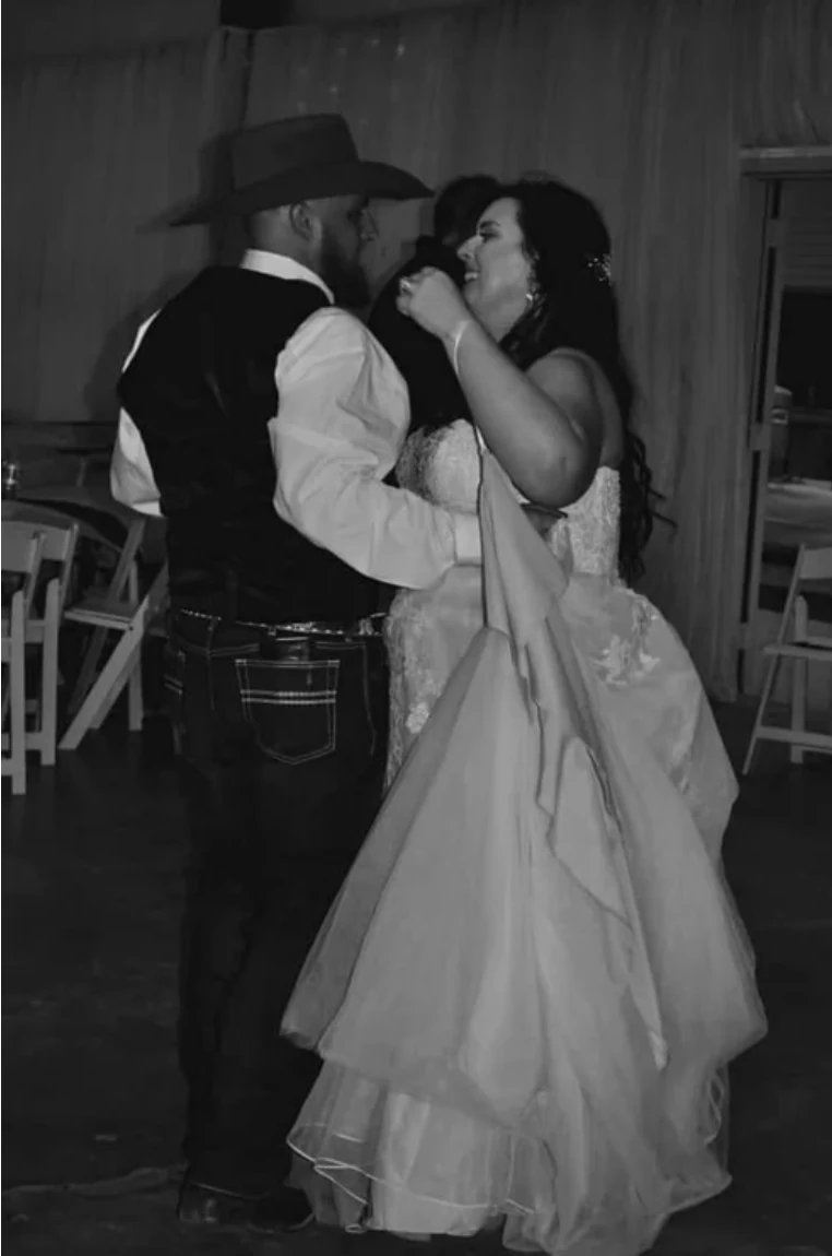 Black and white portrait of Cole and Emily dancing together during their rustic Texas wedding reception