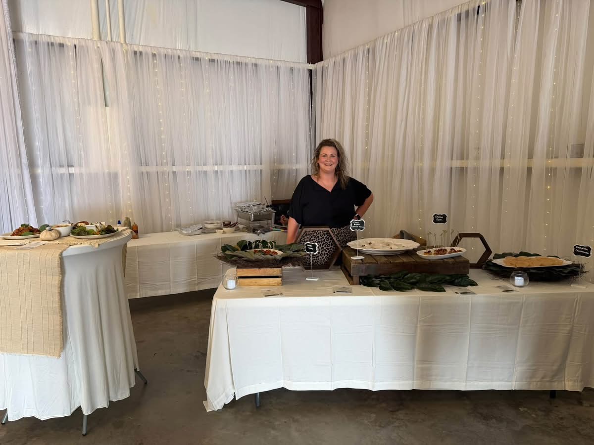 October 2026 Open House at Reverie at Diamond D wedding venue in Normangee, Texas — a catering spread with labeled dishes on white linen tables
