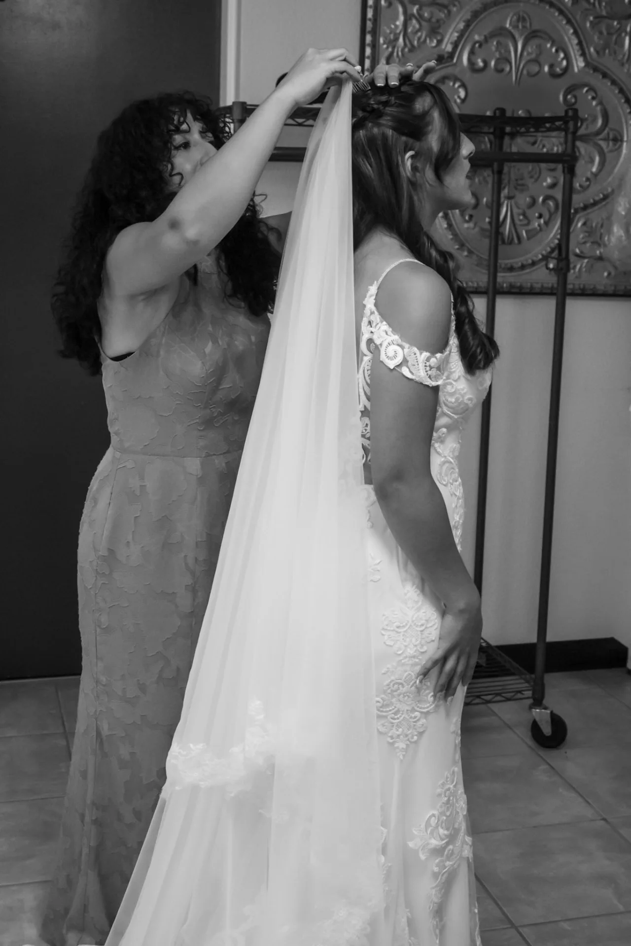 Black and white photo of the bride's veil being placed in the bridal suite before the ceremony