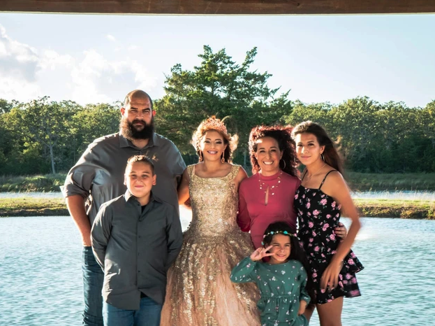 Family portrait beside the lake at Reverie at Diamond D, a quinceanera venue near College Station, Texas