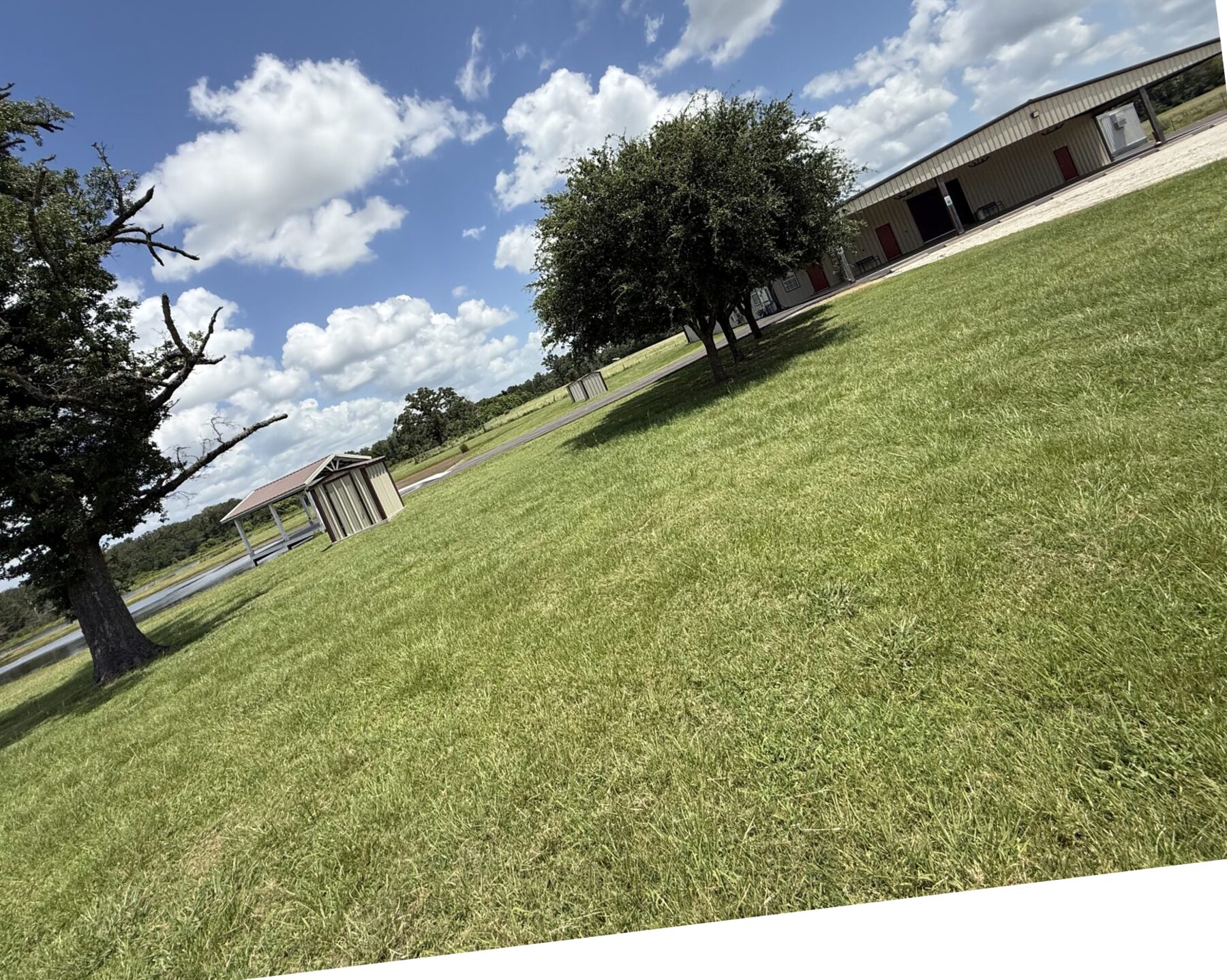 Barn exterior and open grounds at Reverie at Diamond D, a Texas wedding venue in Normangee