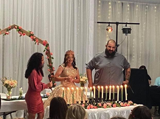 Parents joining the honoree for the candle lighting ceremony in the draped event hall