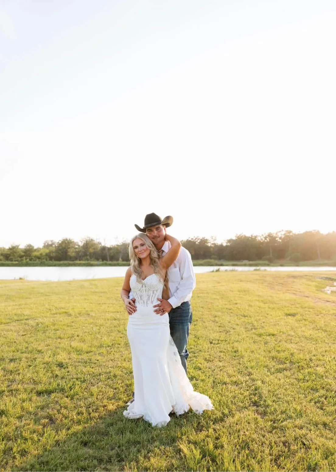 Cannon and Caroline at sunset beside the lake at Reverie at Diamond D wedding venue in Normangee, Texas
