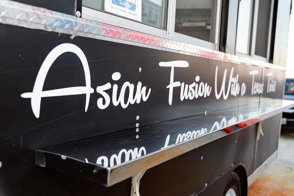 Asian fusion food truck catering parked at the venue