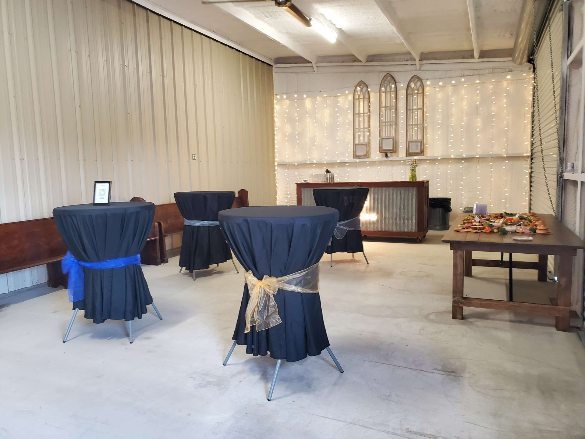 Navy cocktail tables set for a corporate gathering at Reverie at Diamond D in Central Texas