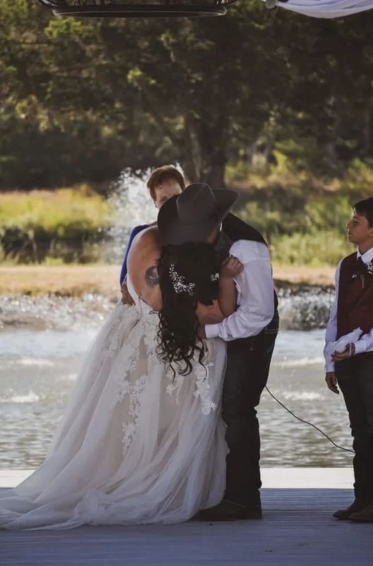 Cole and Emily share their first kiss on the pavilion in front of the lake fountain at Reverie at Diamond D