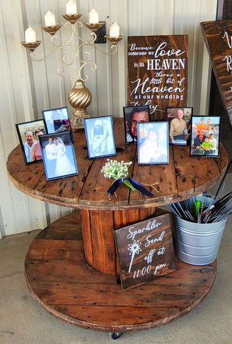 Memory table with framed family photos and wedding signs at Reverie at Diamond D