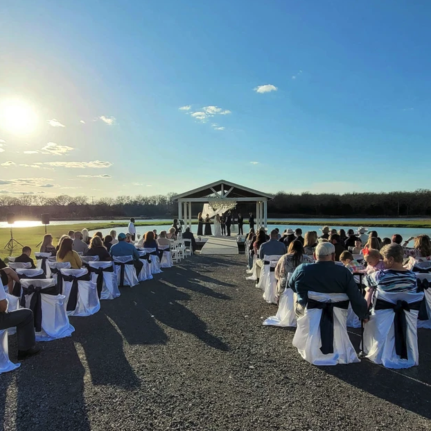 Golden hour outdoor wedding ceremony with seated guests at Reverie at Diamond D in Normangee, Texas