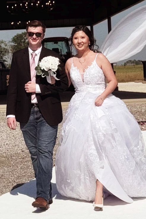 Bride escorted down the aisle with a white rose bouquet at a 2024 Texas wedding at Reverie at Diamond D