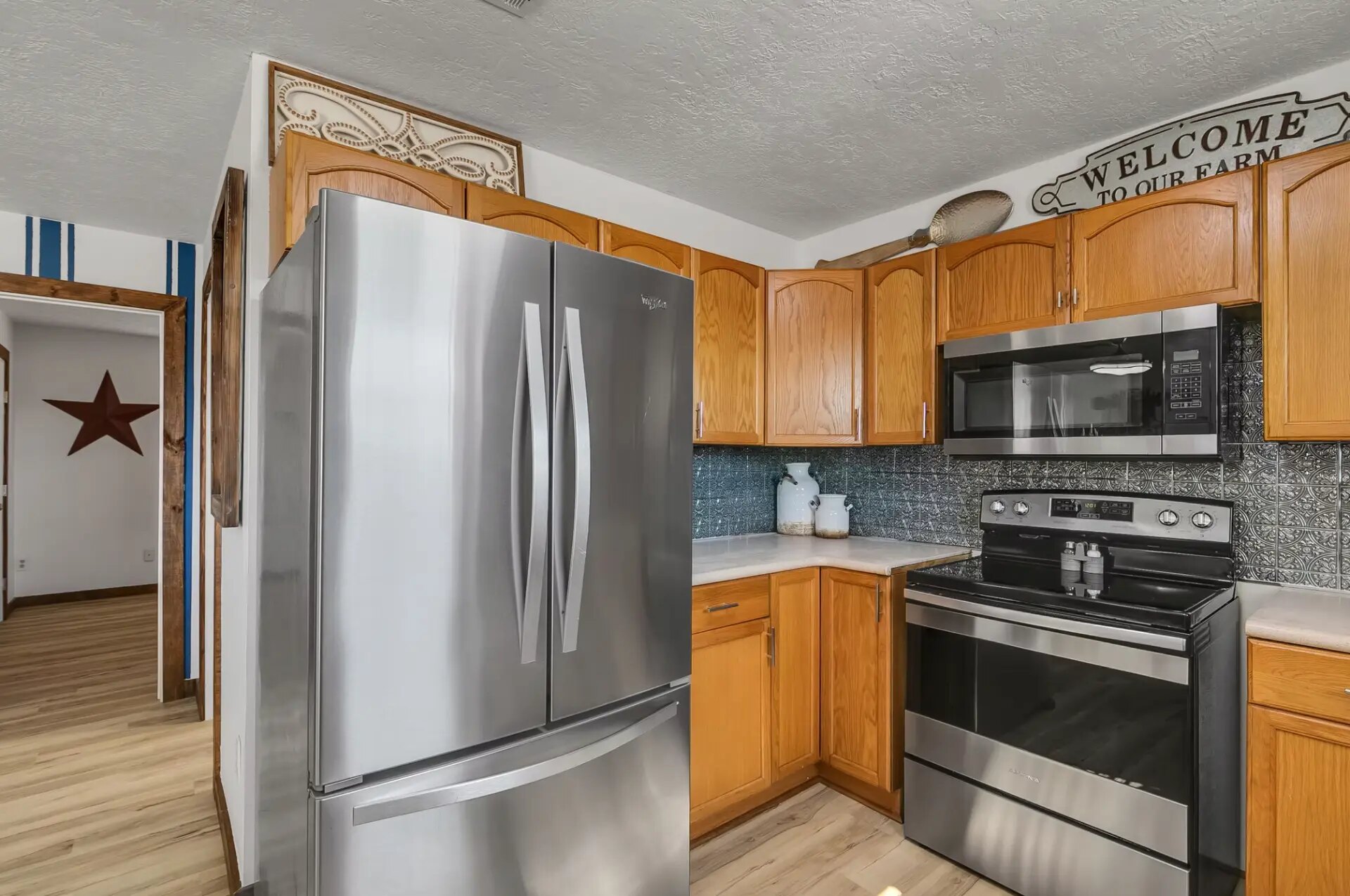Farmhouse kitchen with full-size refrigerator, range and microwave at Reverie at Diamond D