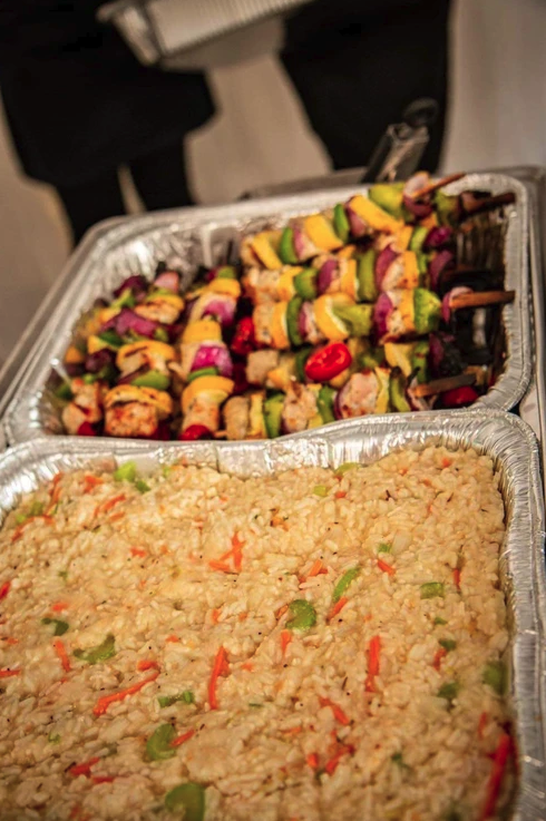 Chicken and vegetable kabobs with rice on the Sweet 16 catering buffet line